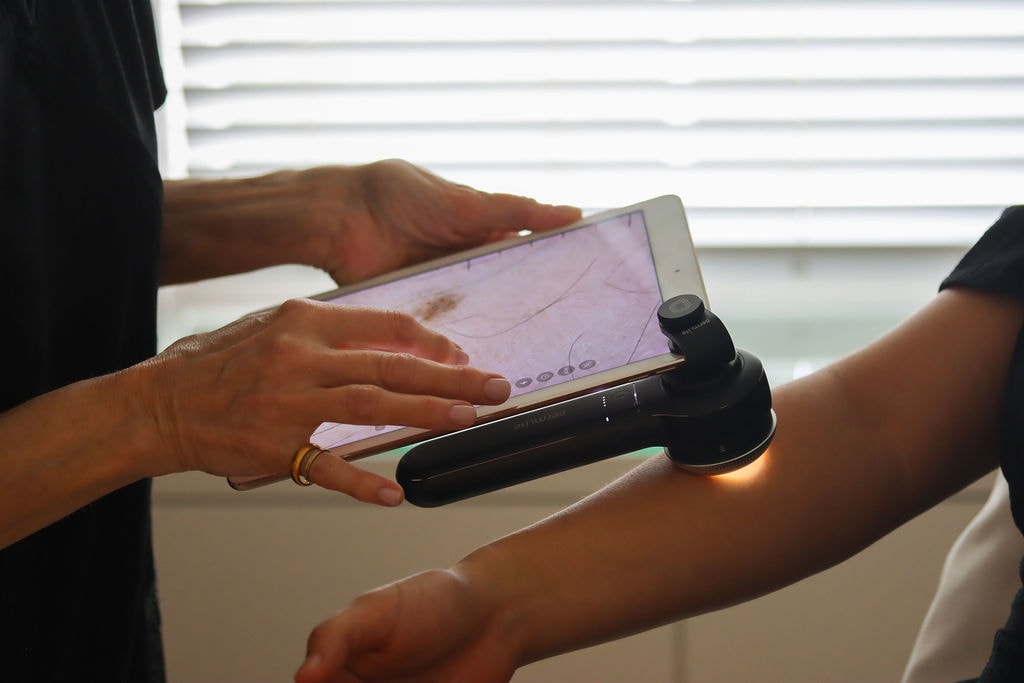 Dr Patti Piper examining a mole at Aesthetica